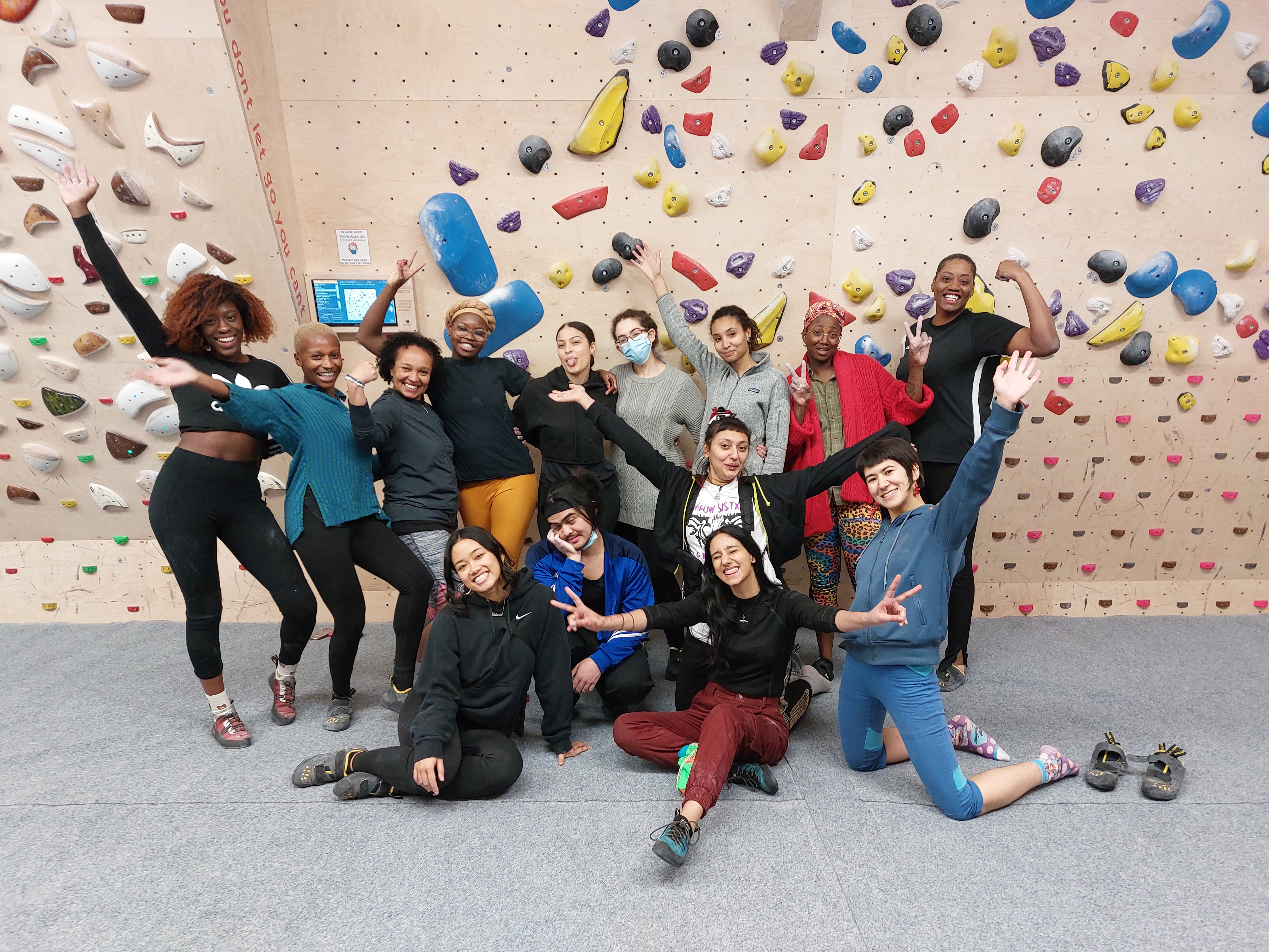 wanderers of colour at a climbing wall